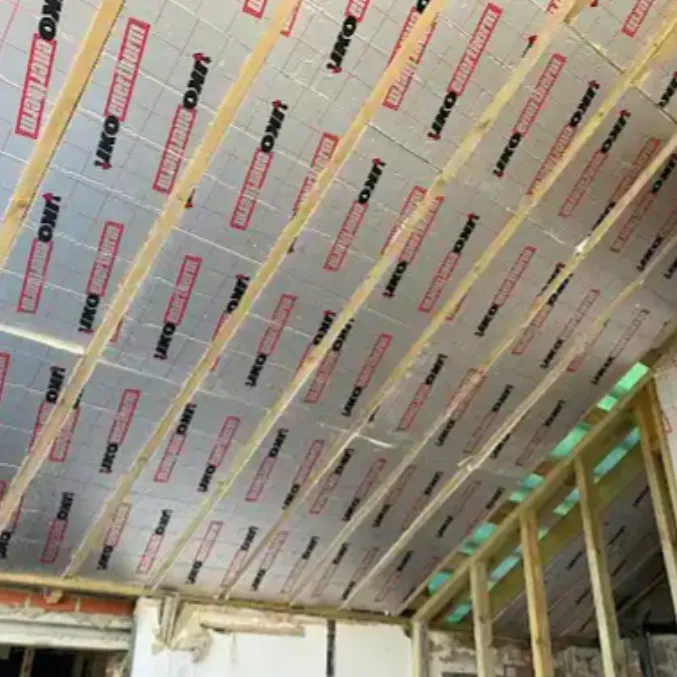 Insulation boards fitted between new roof rafters during a loft build